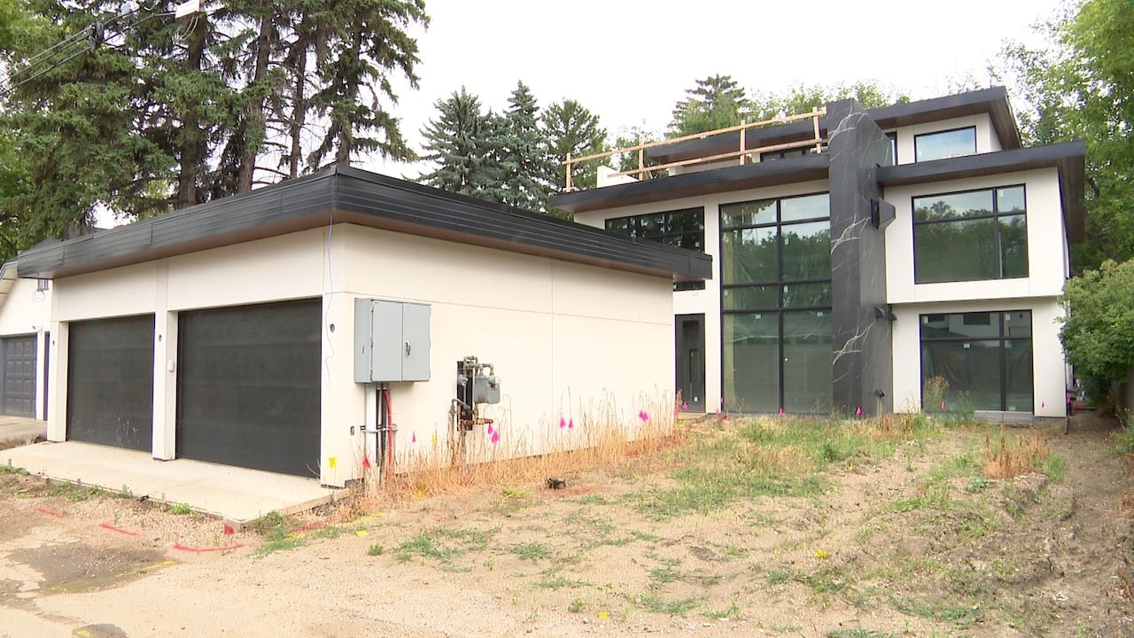 default-92 A large, flat-roofed house that's nearly finished, and a garage.