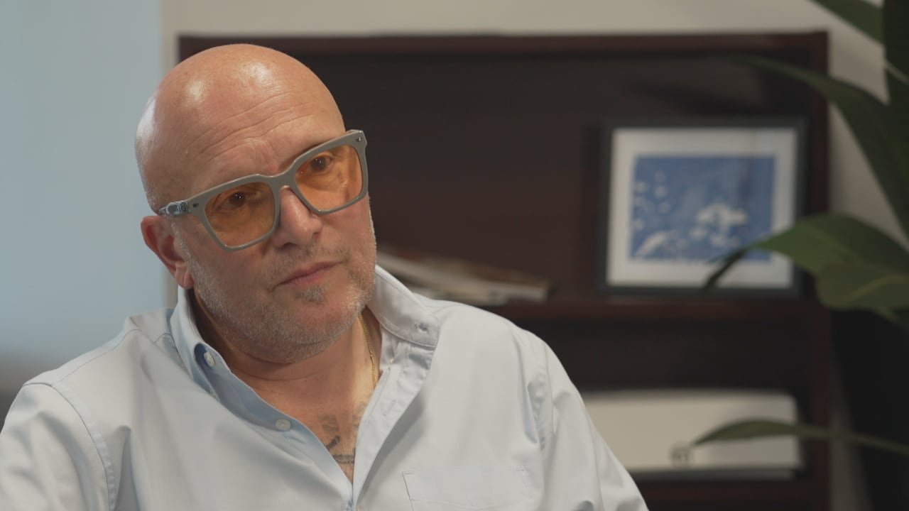 Man in glasses sitting in a chair